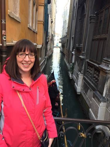 Holly Henrickson in Venice, Italy on a bridge over a canal